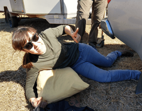 Amellia Formby lying on the ground with a broken leg and giving a thumbs up