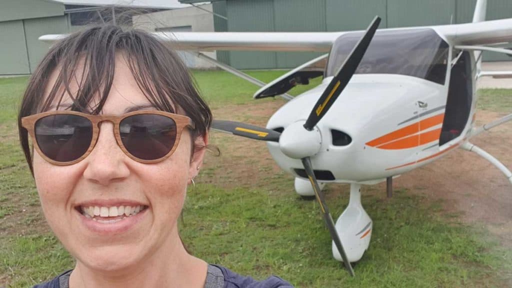 Selfie of Amellia Formby in front of ultralight aircraft