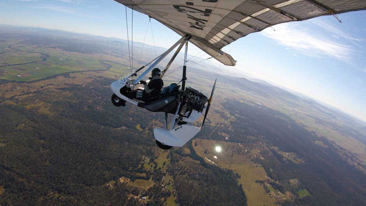 Aerial view of a microlight over the landscape